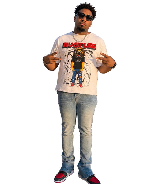 Man wearing a graphic t-shirt with rhinestones and a cityscape in the background 