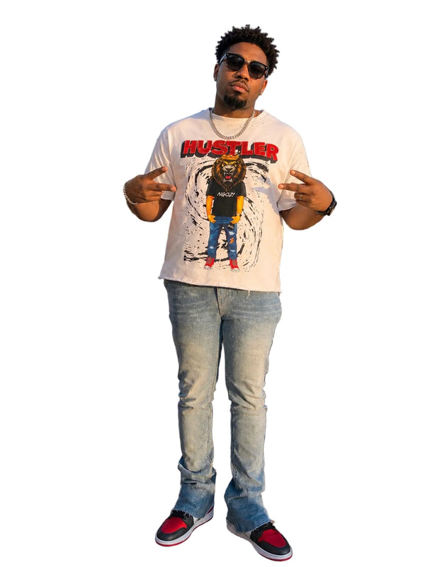 Man wearing a graphic t-shirt with rhinestones and a cityscape in the background 